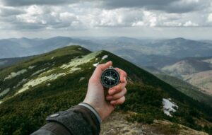 person with compass in the wilderness representing how Houston fractional CFO services provide guidance for businesses