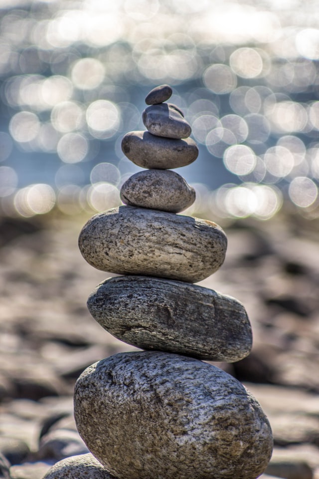 stack of rocks to show how mergers & acquisitions advisory can help build a solid foundation for your M&A deal